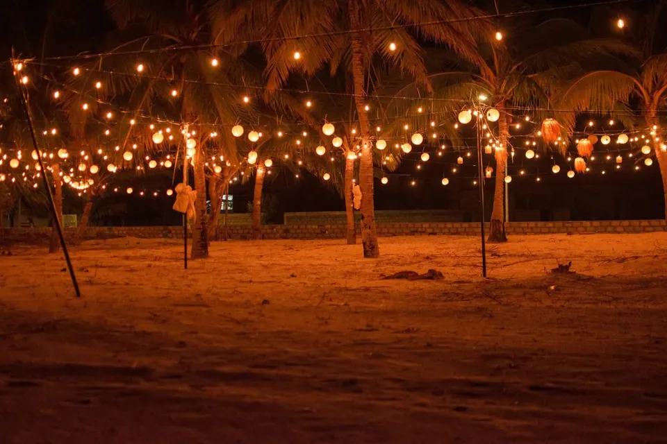 The beach at night under strings of lights