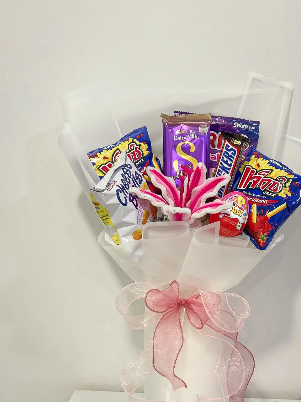 Chocolate and snack bouquet with a pink lily