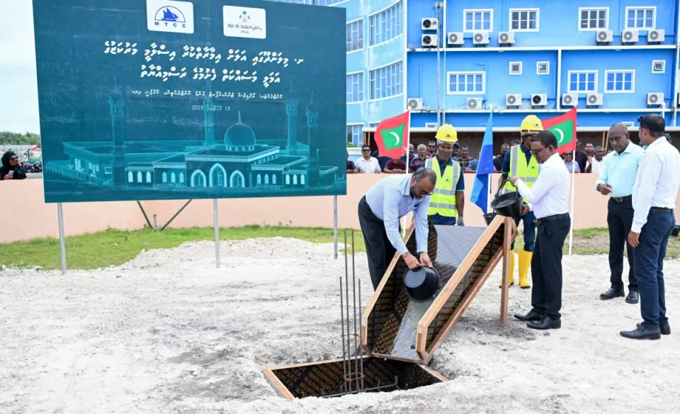 Groundbreaking of the Islamic Centre on 15 Oct 2025: officials pour concrete in front of the MTCC project board, which shows a rendering of the domed centre